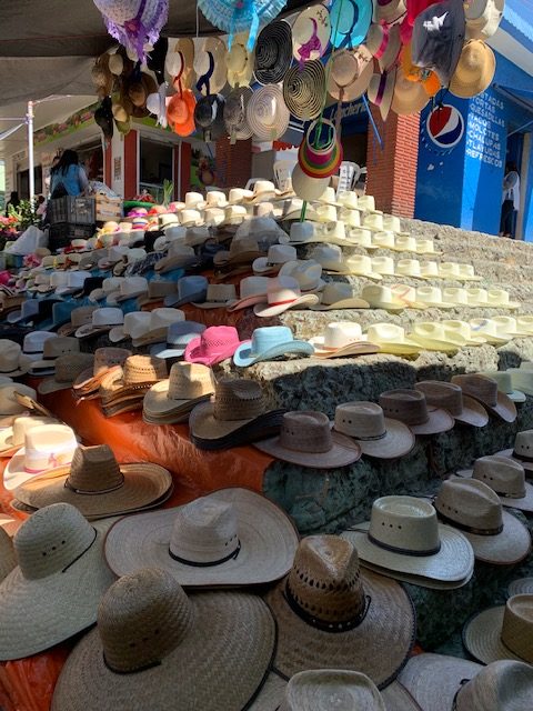 Take your pick of hats at the mercado in Villa de Etla. by Gwen Hyatt