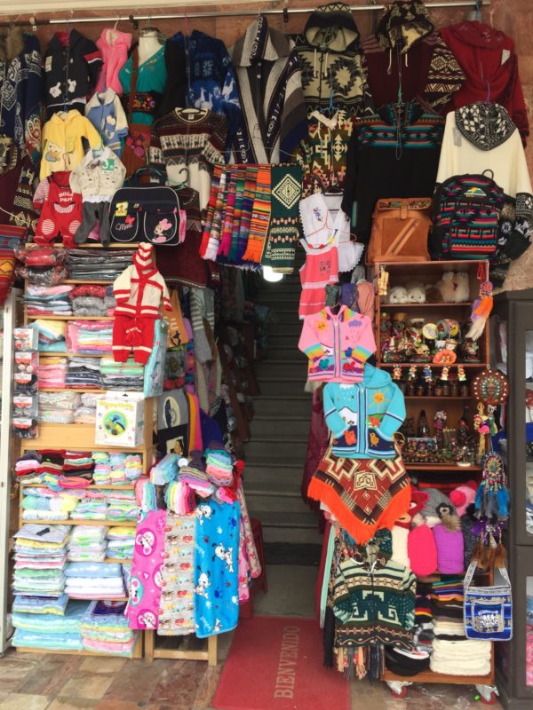Ecuadorian textiles and crafts at the market in Plaza San Francisco in Cuenca, Ecuador by Rachel DeSalvo